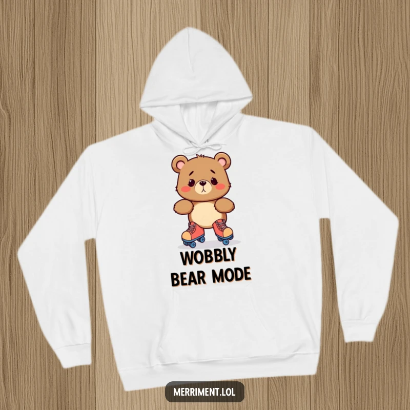 Funny hoodie with a bewildered bear character hilariously attempting to roller skate, captured in a moment of extreme wobbling.