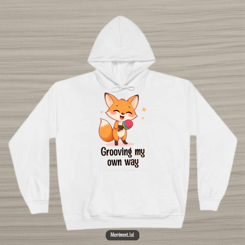 Funny hoodie design of a giggling fox in a dynamic dance, shaking oversized maracas with a joyful expression, perfect for cozy fun.