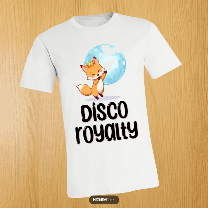 Fox wearing a crown is joyfully bouncing a giant shimmering disco ball, printed on a hilarious t-shirt.