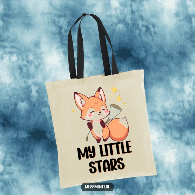Funny fox tote bag depicting a playful fox character catching falling stars in a sparkly net, a practical and humorous accessory.